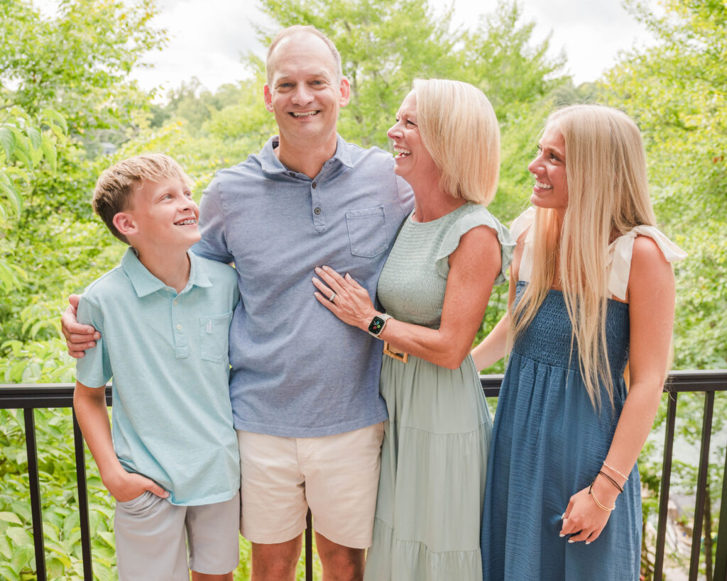 dad looking at camera and family laughing